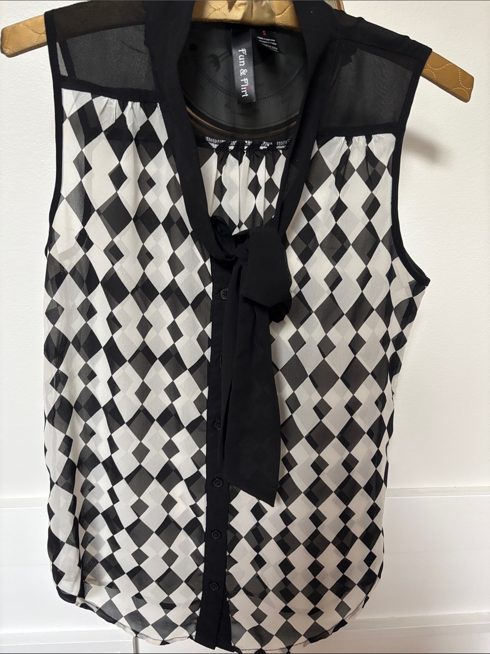 black and white diamond/harlequin patterned button-up blouse
